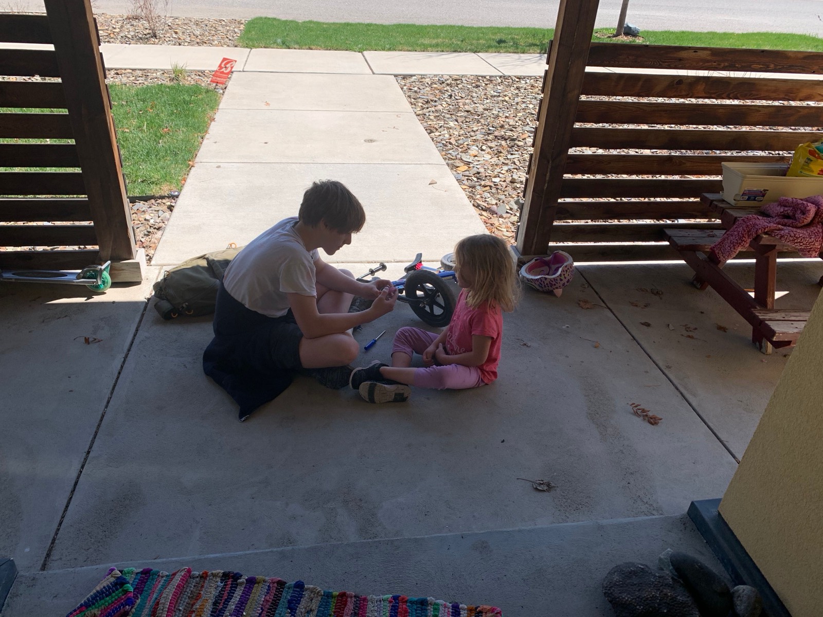 Big brother helping fix sisters bike